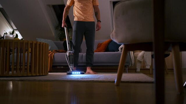 Janitor hoovering carpet with vacuum cleaner indoors, closeup