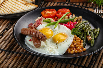Traditional Engrlish breakfast with egg  and sausages