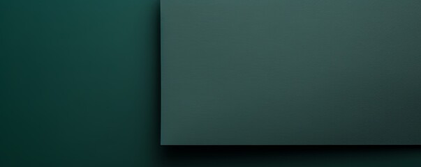 Green background with dark green paper on the right side, minimalistic background, copy space concept, top view, flat lay