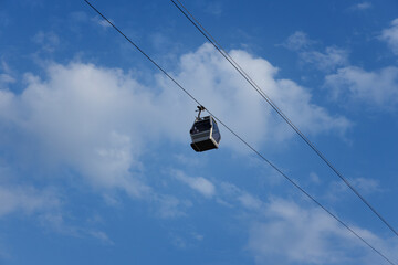 funicular cabin against the background of clouds and bright blue sky. selective focus . High quality photo