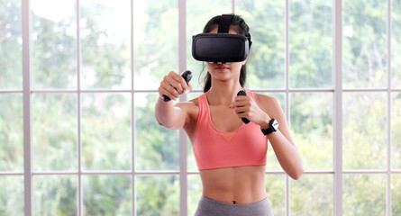 E sport, Happy asian woman wearing virtual reality headset for interactive excercise at home, Asia girl playing vr while workout fitness, Female and wearable technology