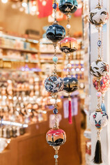 Turkish souvenir, Hanging glass ball with ornaments, blurred souvenir shop background featuring...