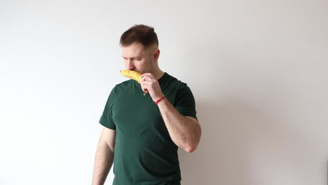 Man takes banana out of his pocket and sniffs it. Men's health