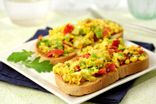 Scrambled eggs on toast with spring garlics.