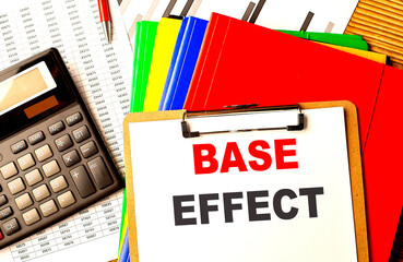 BASE EFFECT text on clipboard with calculator and color folder