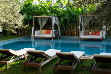 Relaxation Area Inside the Pool Surrounded by Tropical Trees Photo, Alacati Cesme, Izmir Turkiye (Turkey)