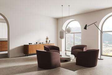 Stylish living room interior with armchairs and sideboard, panoramic window