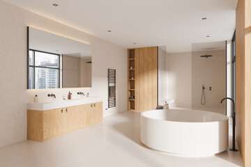 Stylish beige hotel bathroom interior with double sink, tub and glass shower