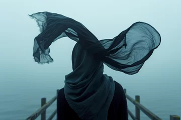 Keuken foto achterwand AI generated illustration of a woman with a scarf standing on a pier in the wind © Wirestock