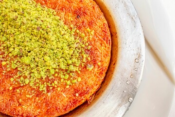 Plate of fresh Kunefe, sweet cheese pastry from Turkish cuisine