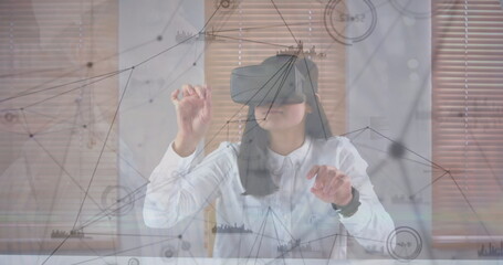 Image of data processing over biracial businesswoman using vr headset