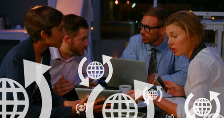 Image of arrows around globes over diverse coworkers discussing strategy in cafes