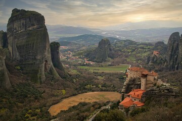 Scenic view of a beautiful landscape with mountains, valleys, and buildings seen in Meteora, Greece