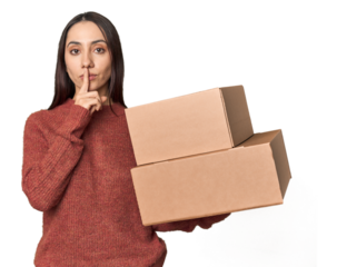 Caucasian young woman with moving boxes on studio background keeping a secret or asking for silence.