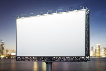 Blank white billboard on city buildings background at night, perspective view. Mockup, advertising...