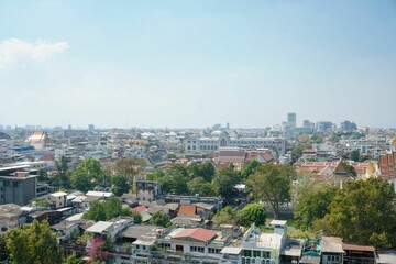 Obraz premium Drone shot of Bangkok cityscape with trees and blue sky