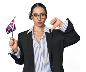 Businesswoman with UK flag, symbolizing international business on studio background showing a dislike gesture, thumbs down. Disagreement concept.