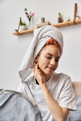 cheerful extravagant person with white hair towel looking in mirror during morning routine at home