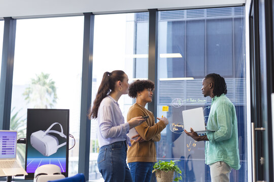 Diverse team discussing VR graphs in office