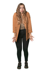 Fototapeta premium Studio portrait of a blonde Caucasian woman shrugs shoulders and open eyes confused.