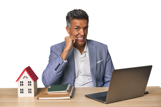 Middle-aged Hispanic businessman with real estate theme biting fingernails, nervous and very anxious.