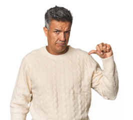Middle-aged Latino man showing thumb down, disappointment concept.