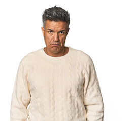 Fototapeta premium Middle-aged Latino man sad, serious face, feeling miserable and displeased.