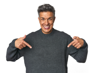 Middle-aged Latino man surprised pointing with finger, smiling broadly.
