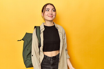 Young traveler woman with her backpack dreaming of achieving goals and purposes