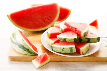 Slices of watermelon on white wooden table.