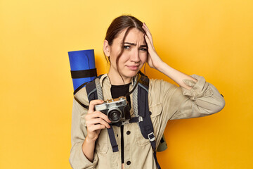Photographer with gear ready to explore being shocked, she has remembered important meeting. - obrazy, fototapety, plakaty