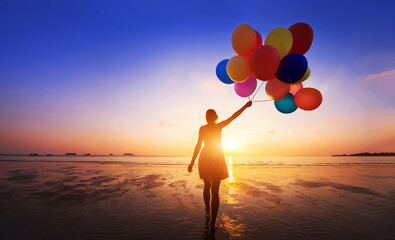 woman with multicolored balloons on the beach at sunset, colorful balloons, color inspiration - obrazy, fototapety, plakaty