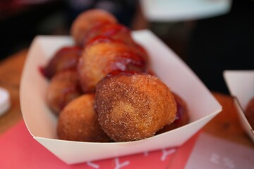 Close-up shot of fried sugar balls in a street market
