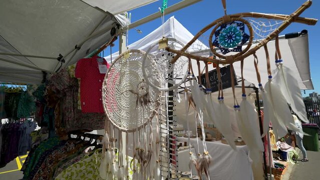 Close-up view of dreamcatchers hanging in an open-air market
