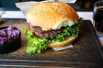 Classic hamburger with lettuce on a wooden plate, Belgium
