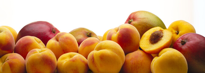Variety of peaches and mango with white background