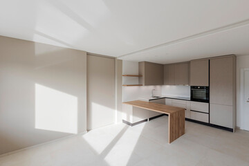 Interior of a modern kitchen with a wooden table or worktop. Everything is new and there are no objects around