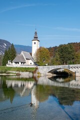 Fototapeta na wymiar Church of St John the Baptist near lake Bohinj, Slovenia in autumn