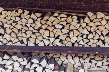 Chopped firewood. Timber stacked under a shed. Wood, fuel, winter, heating, energy. Firewood...