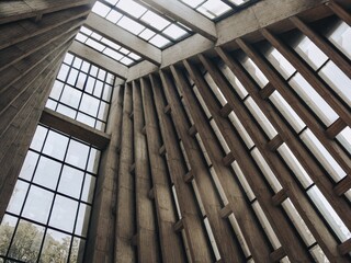 Low-angle shot of a building's interior with panoramic windows and concrete constructions