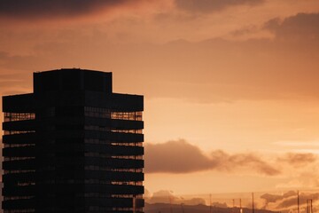 Beautiful shot of a building silhouette with the background of the sunset sky