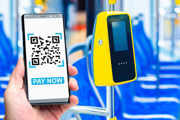 Bus terminal for payment. Phone in man hand. Payment for travel via qr code. Payment terminal on...