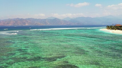 Aerial view of sea with emerald water near beach