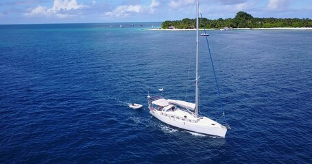 Fototapeta premium Scenic view of boat in the tranquil Indian Ocean near the beautiful beach on a summer day