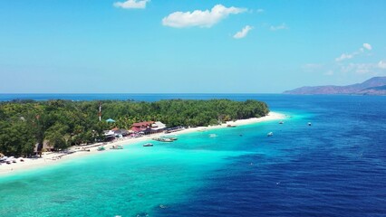 Aerial view of an island with houses and trees by the ocean
