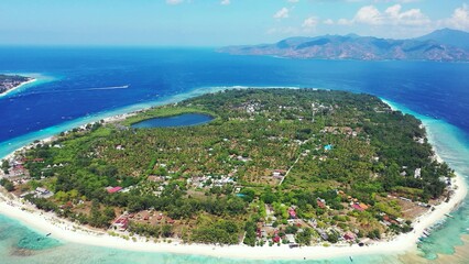Aerial drone shot of a populated tropical island in Southeast Asia