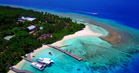 Aerial drone shot of a tropical island in the Maldives and the Indian Ocean