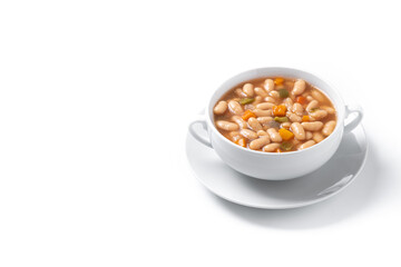 White beans soup with vegetables in white bowl isolated on white background. Copy space