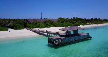 Wooden resort hotel near the shore on the Maldives on blue sky background