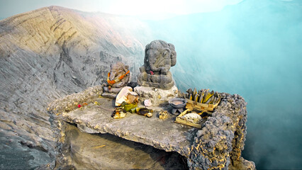 Ancient stone statue of Ganesha stands on a top of volcano Bromo